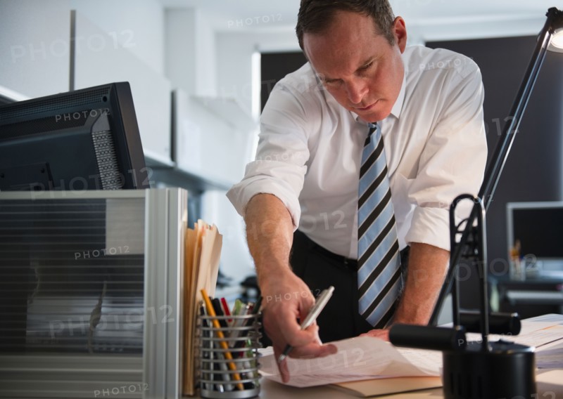 Businessman working in office. Photo : Jamie Grill