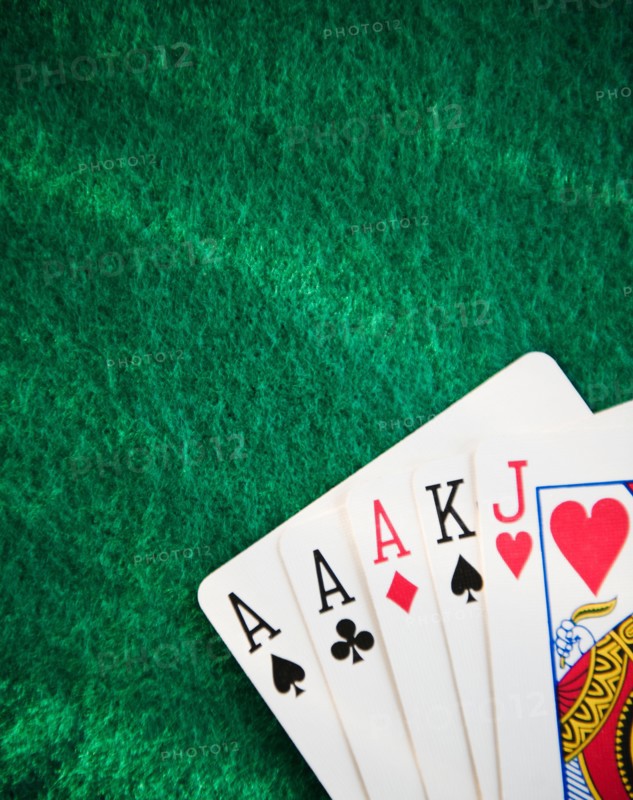 Close up of hand of cards on green felt. Photo: Jamie Grill
