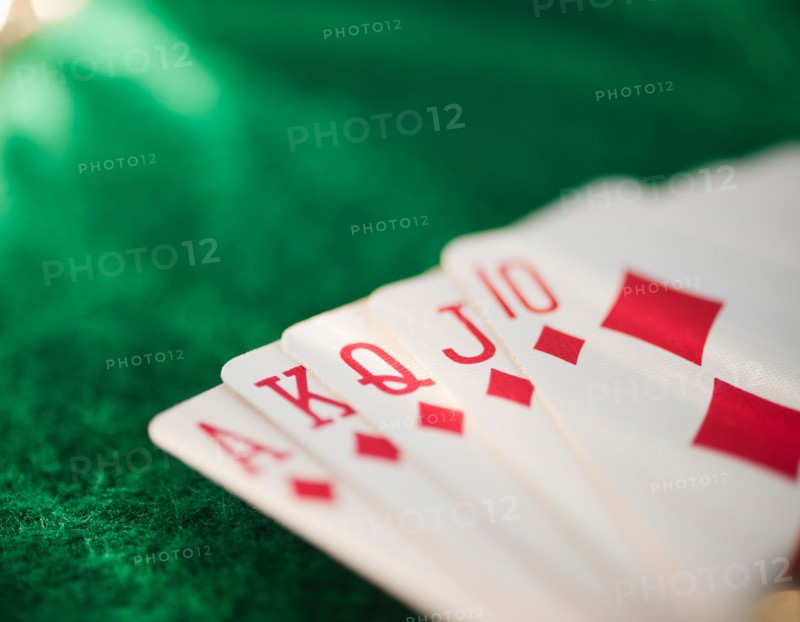 Close up of hand of cards on green felt. Photo: Jamie Grill