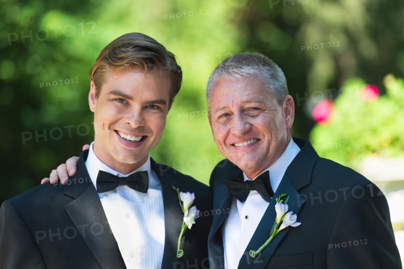 Portrait of father with bridegroom at wedding.