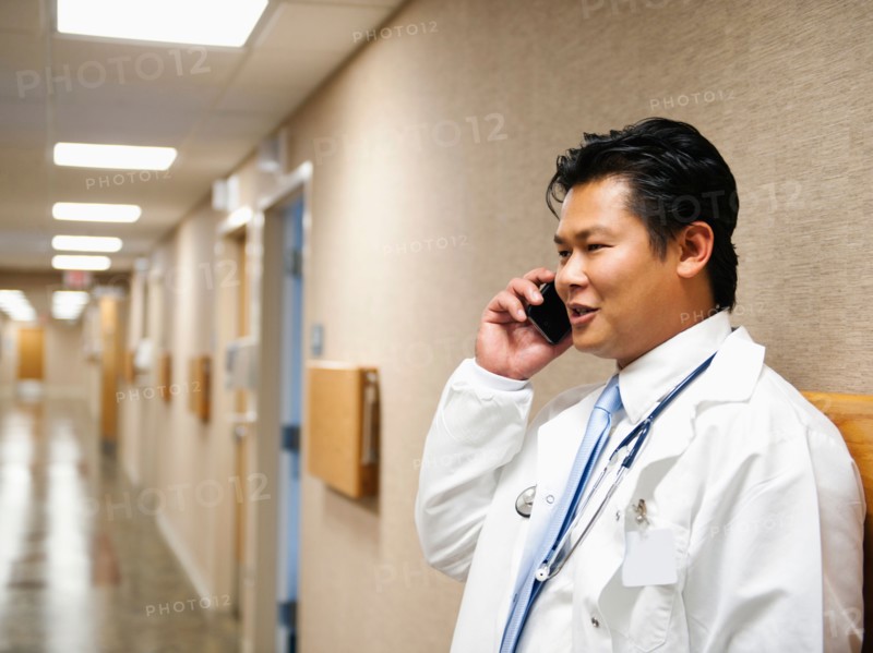 Portrait of doctor talking on mobile phone.