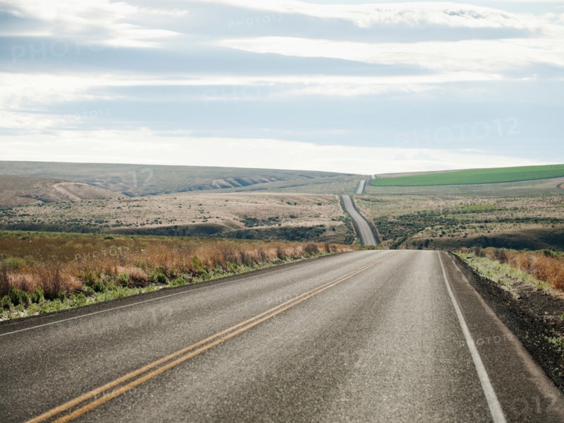 USA, Oregon, Boardman, Rolling landscape with empty road.