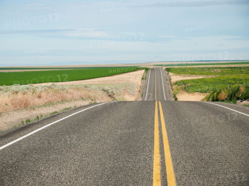 USA, Oregon, Boardman, Rolling landscape with empty road.