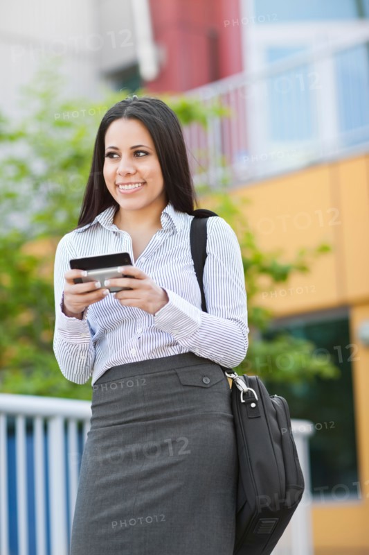 Young businesswoman text-messaging. Photo: Take A Pix Media