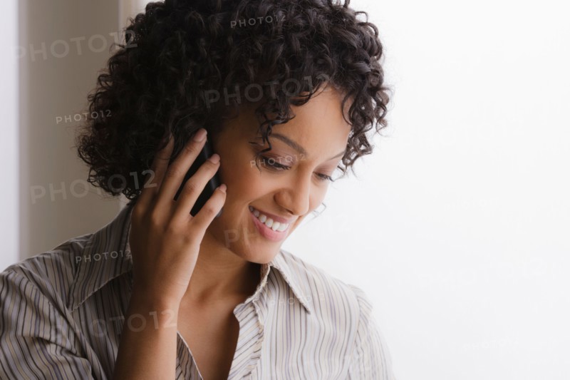 Portrait of smiling businesswoman on phone. Photo : Rob Lewine