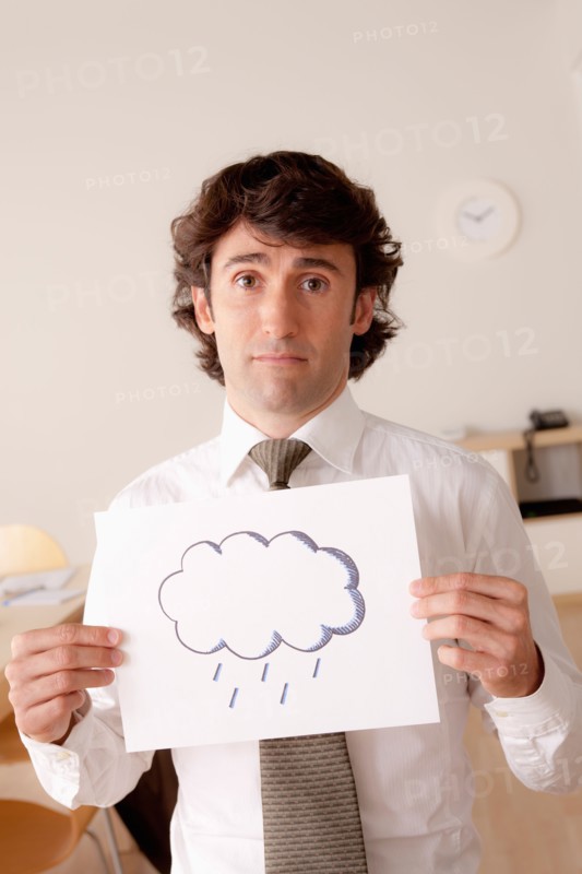 Studio portrait of businessman holding sheet of paper with cloud drawing. Photo: Rob Lewine