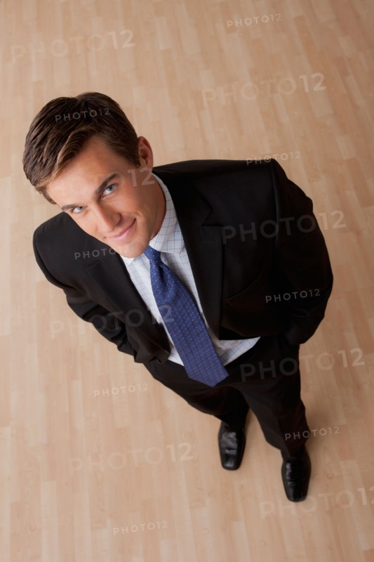 Portrait of young businessman smiling. Photo: Rob Lewine