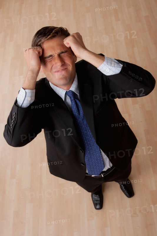 Portrait of young frustrated businessman . Photo: Rob Lewine