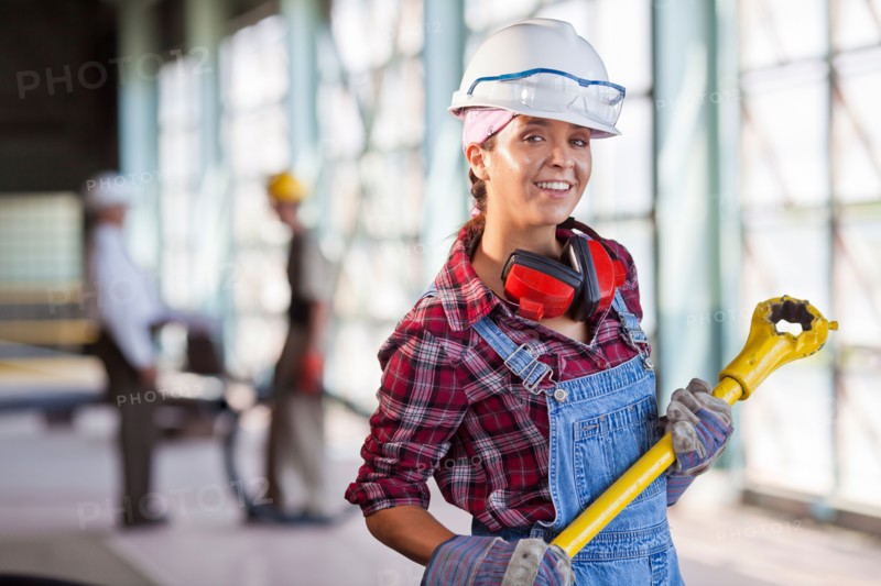 Portrait of female manual worker wearing hardhat. Photo: db2stock