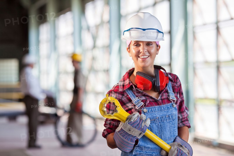 Portrait of female manual worker wearing hardhat. Photo: db2stock