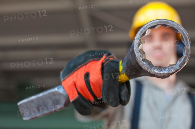 Portrait of male manual worker holding tool. Photo : db2stock