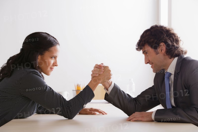 Business man and business woman armwrestling. Photo: Rob Lewine