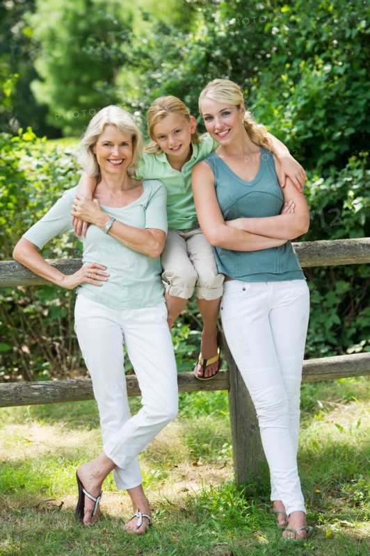 Portrait of girl (10-11) with mother and grandmother.