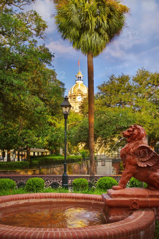 USA, Georgia, Savannah, Fountain in park with dome of City Hall in background.