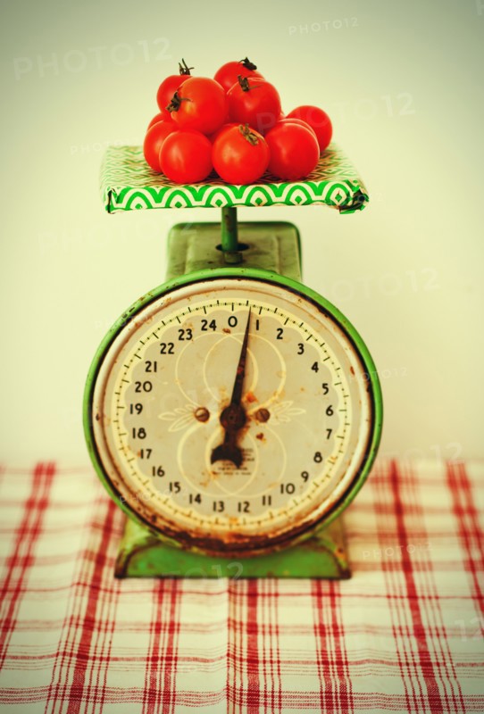 Studio shot of tomatoes on scales.