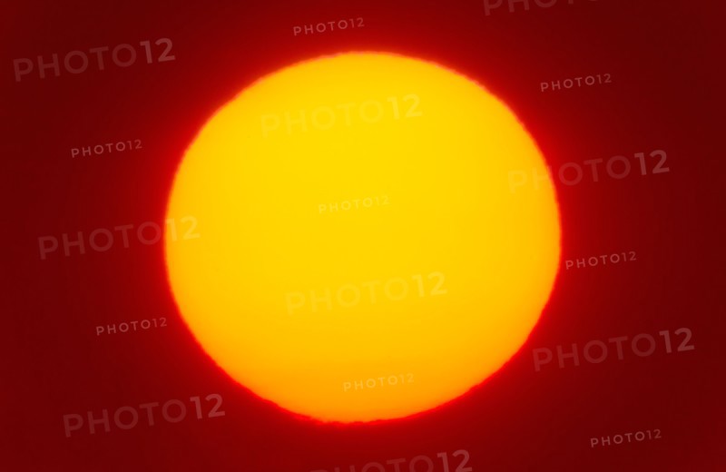 Close-up of large red sun.