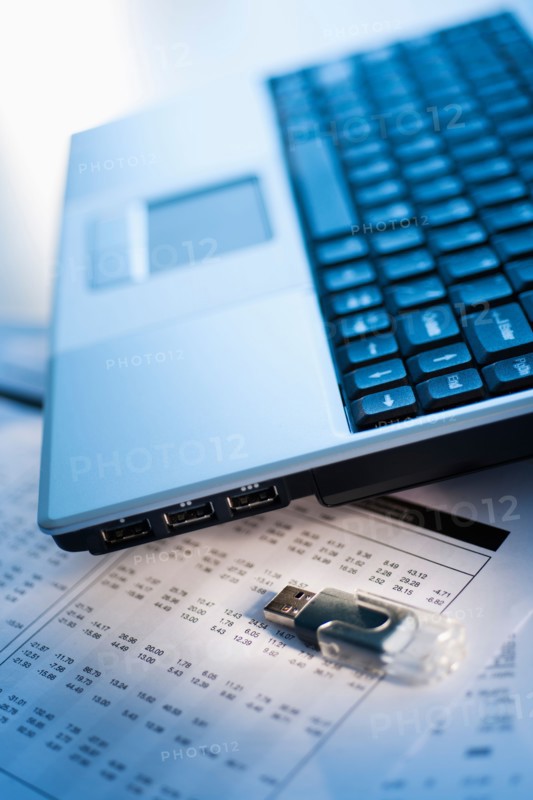 Studio shot of laptop with memory stick.