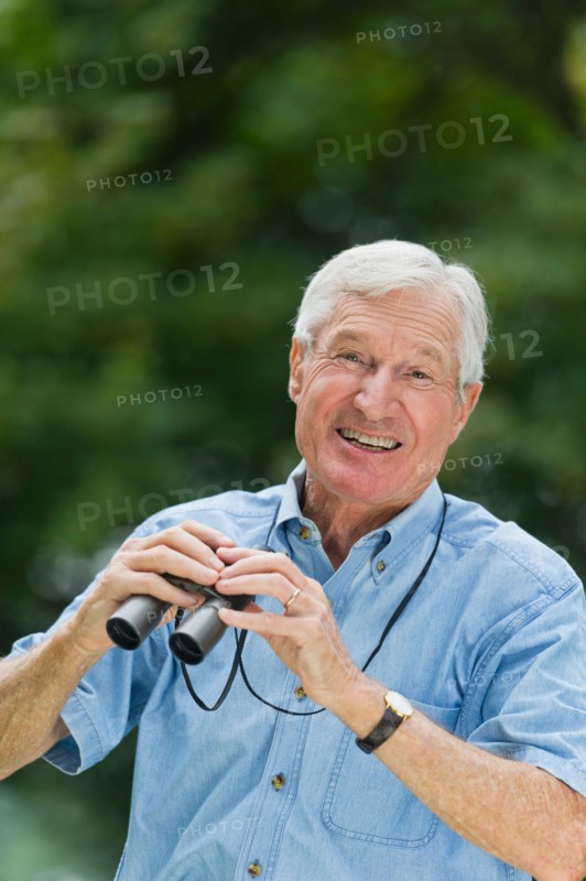 Senior man with binoculars.