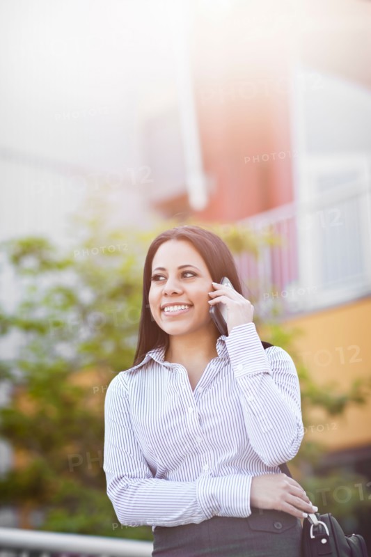 Young businesswoman talking on phone. Photo: Take A Pix Media