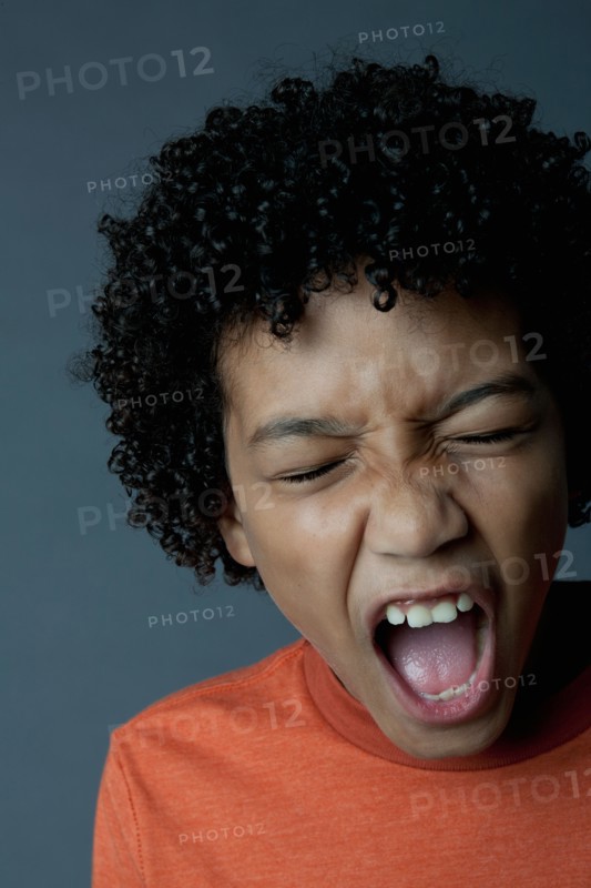 Studio portrait of boy (8-9) screaming. Photo: Rob Lewine