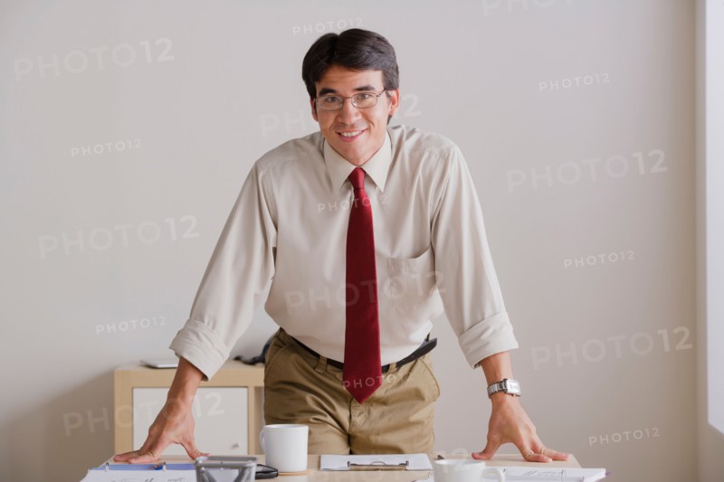 Portrait of smiling businessman in office. Photo : Rob Lewine