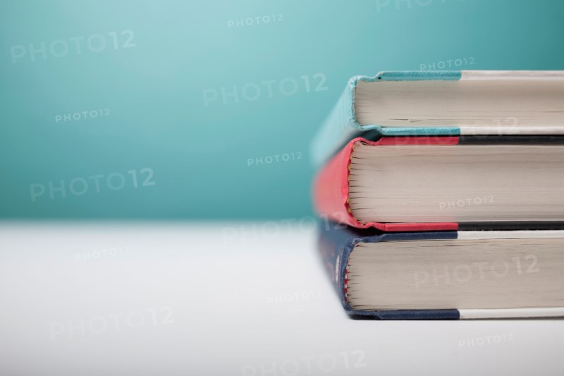 Studio shot of three books in stack. Photo : Winslow Productions