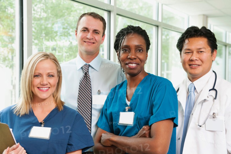 Doctor, hospital manager and two nurses posing for portrait.