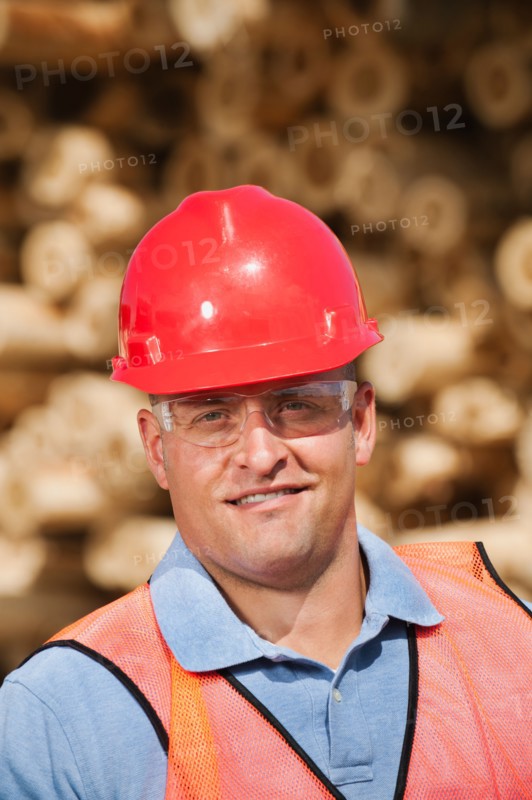 Engineer in front of stack of timber. Photo: Erik Isakson