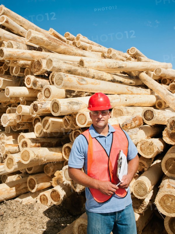 Engineer in front of stack of timber. Photo: Erik Isakson