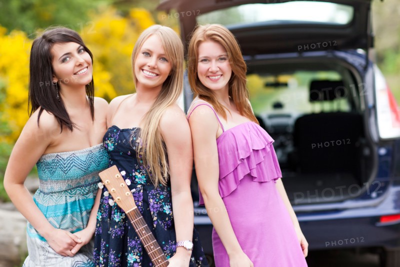Portrait of young women with guitar by car. Photo: Take A Pix Media