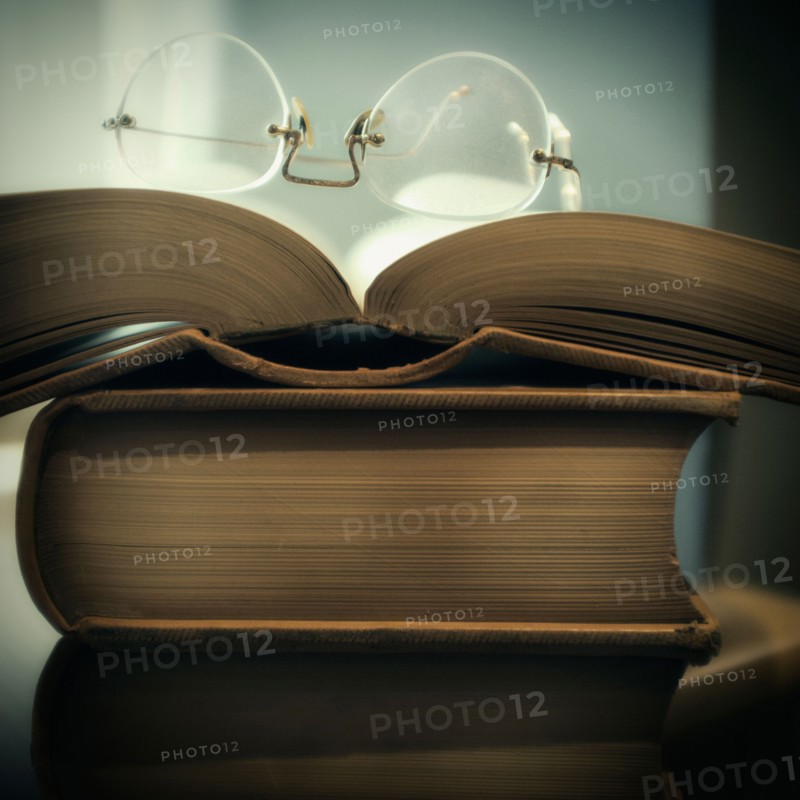 Studio shot of books and eyeglasses.
