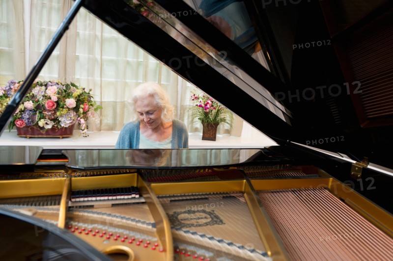 Senior woman playing piano.