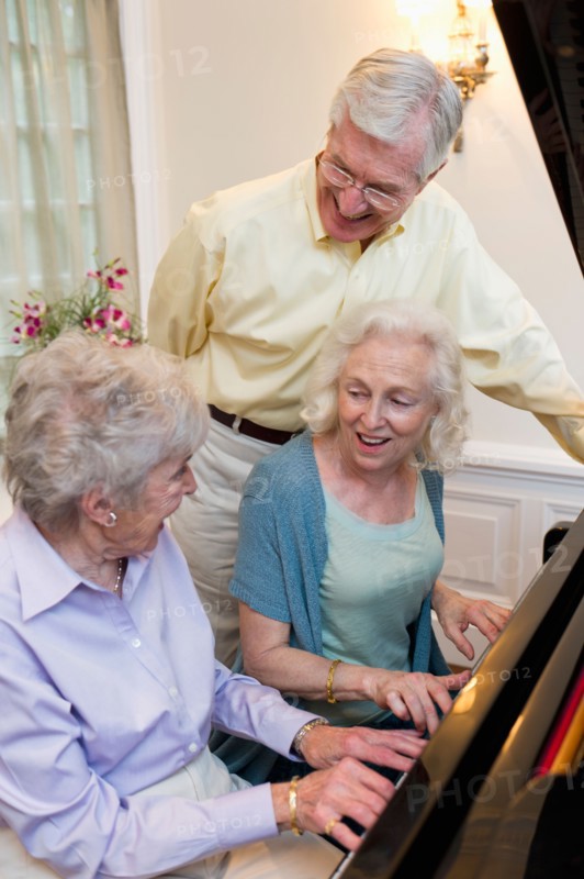 Seniors playing piano and singing.