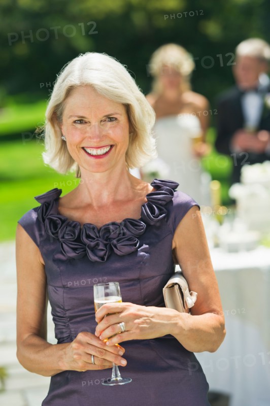 Portrait of mother of bride at wedding reception.