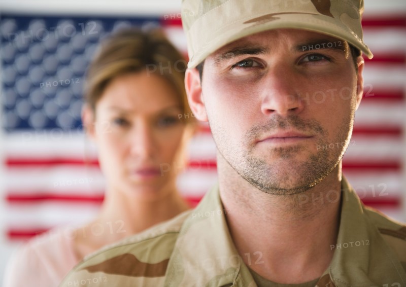 Close up ofsoldier and his girlfriend with american flag in background. Photo: Jamie Grill