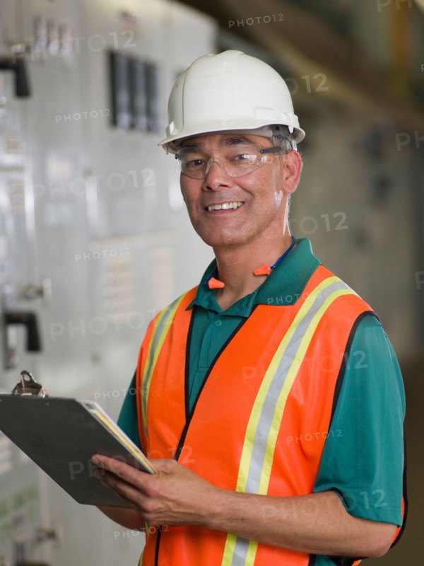 Portrait of industrial worker in hard hat. Photo: db2stock