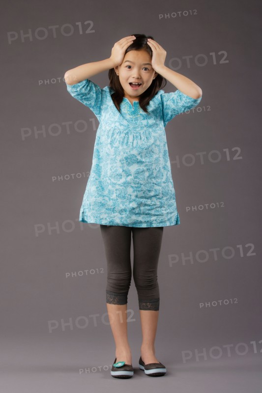 Portrait of smiling girl (8-9), studio shot. Photo : Rob Lewine