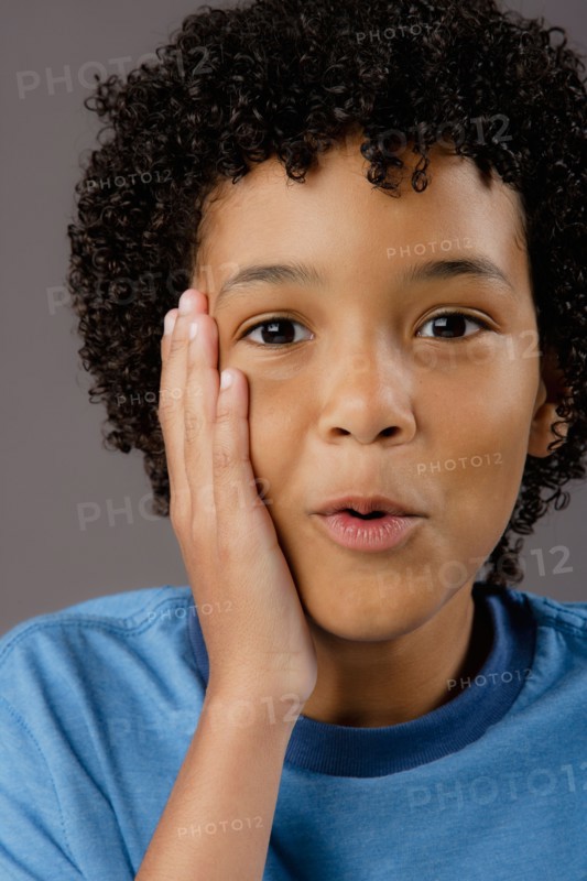 Portrait of surprised boy (8-9), studio shot. Photo : Rob Lewine