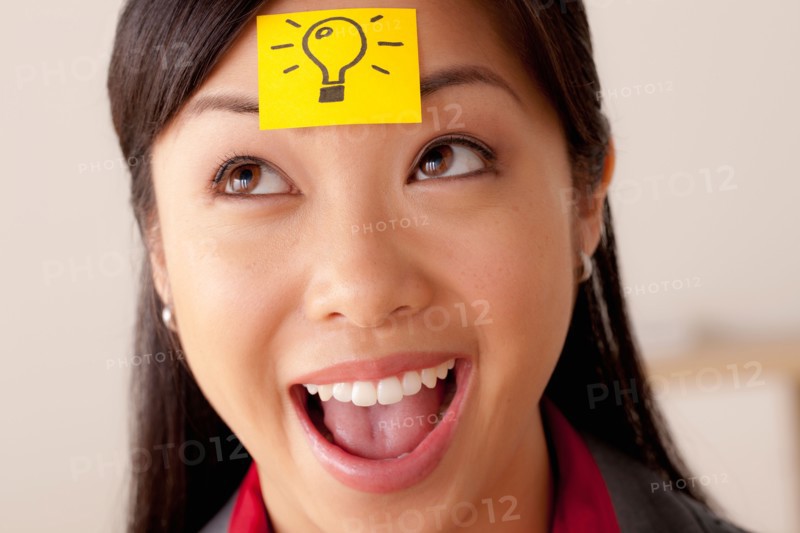 Studio portrait of businesswoman with adhesive note on forehead. Photo : Rob Lewine