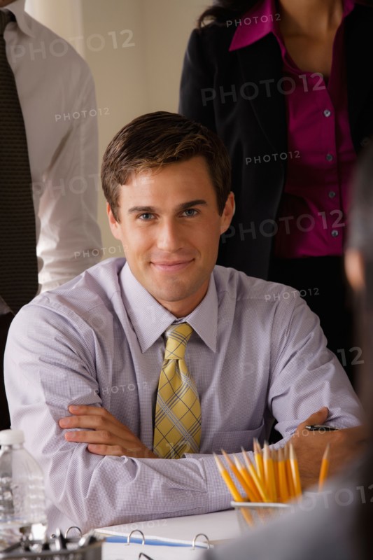 Portrait of smiling businessman in office. Photo : Rob Lewine