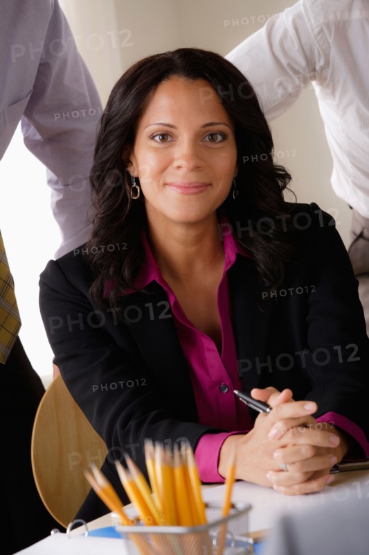 Portrait of smiling businesswoman at business meeting. Photo : Rob Lewine