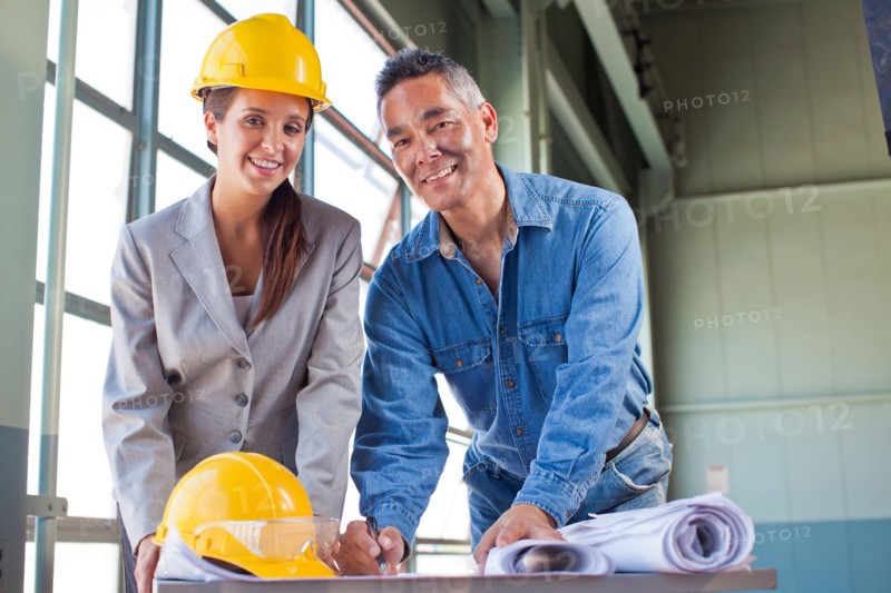 Portrait of architects drawing blueprint. Photo: db2stock
