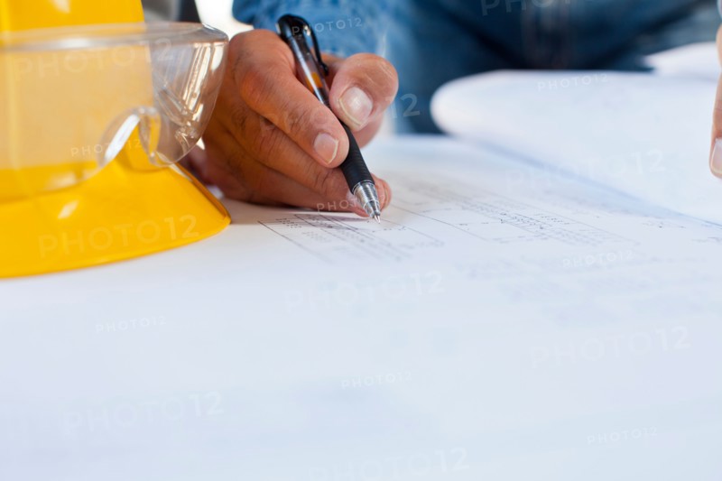 Architect's hand drawing blueprint. Photo : db2stock
