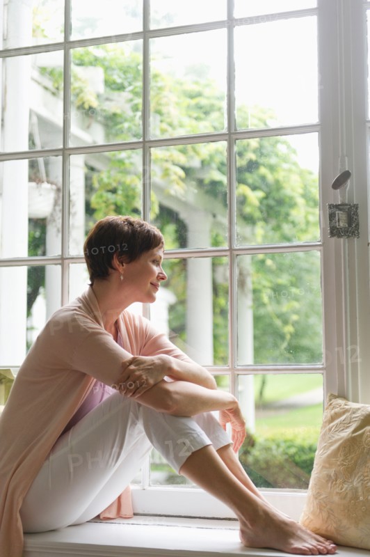 Woman looking through window.