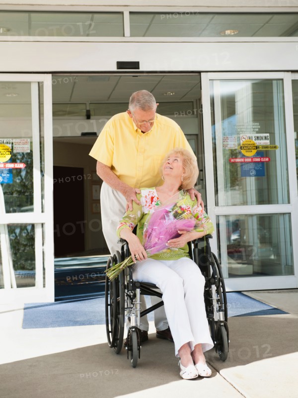 Senior people going out from hospital.