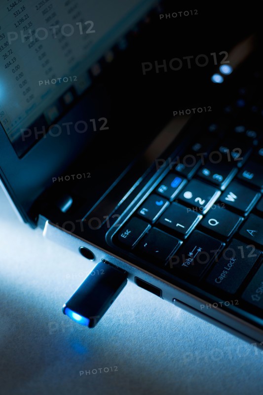 Studio shot of flash drive in laptop.