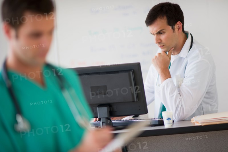 Doctor looking at computer.