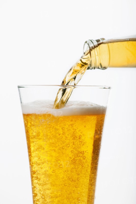 Beer pouring into glass, studio shot.