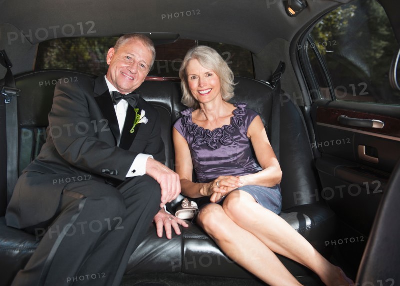Portrait of parents of bride in limousine.