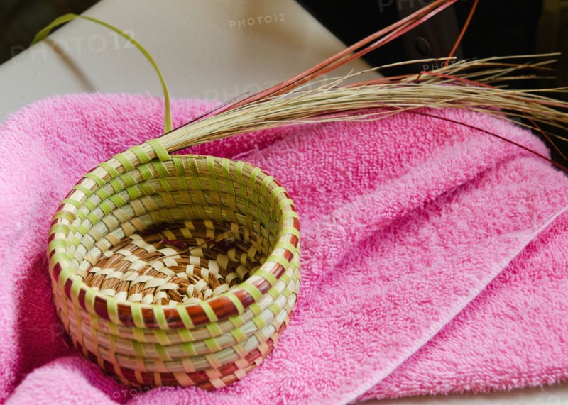 USA, South Carolina, Charleston, Close up of sweetgrass basket on towel.